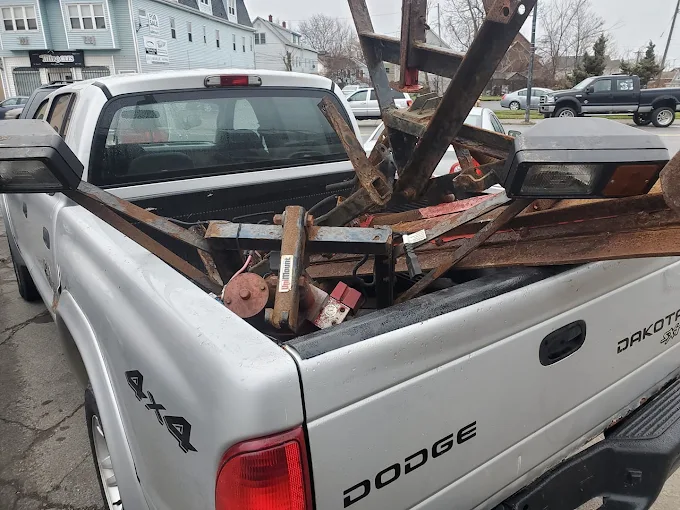 White Dodge Dakota pickup loaded with scrap metal