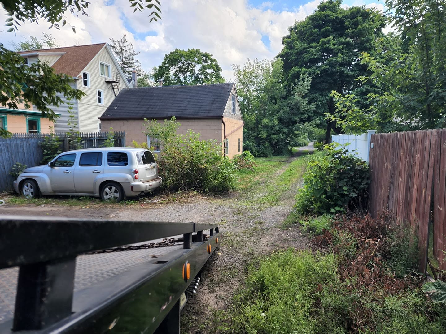 Silver Chevrolet HHR picked up from a backyard